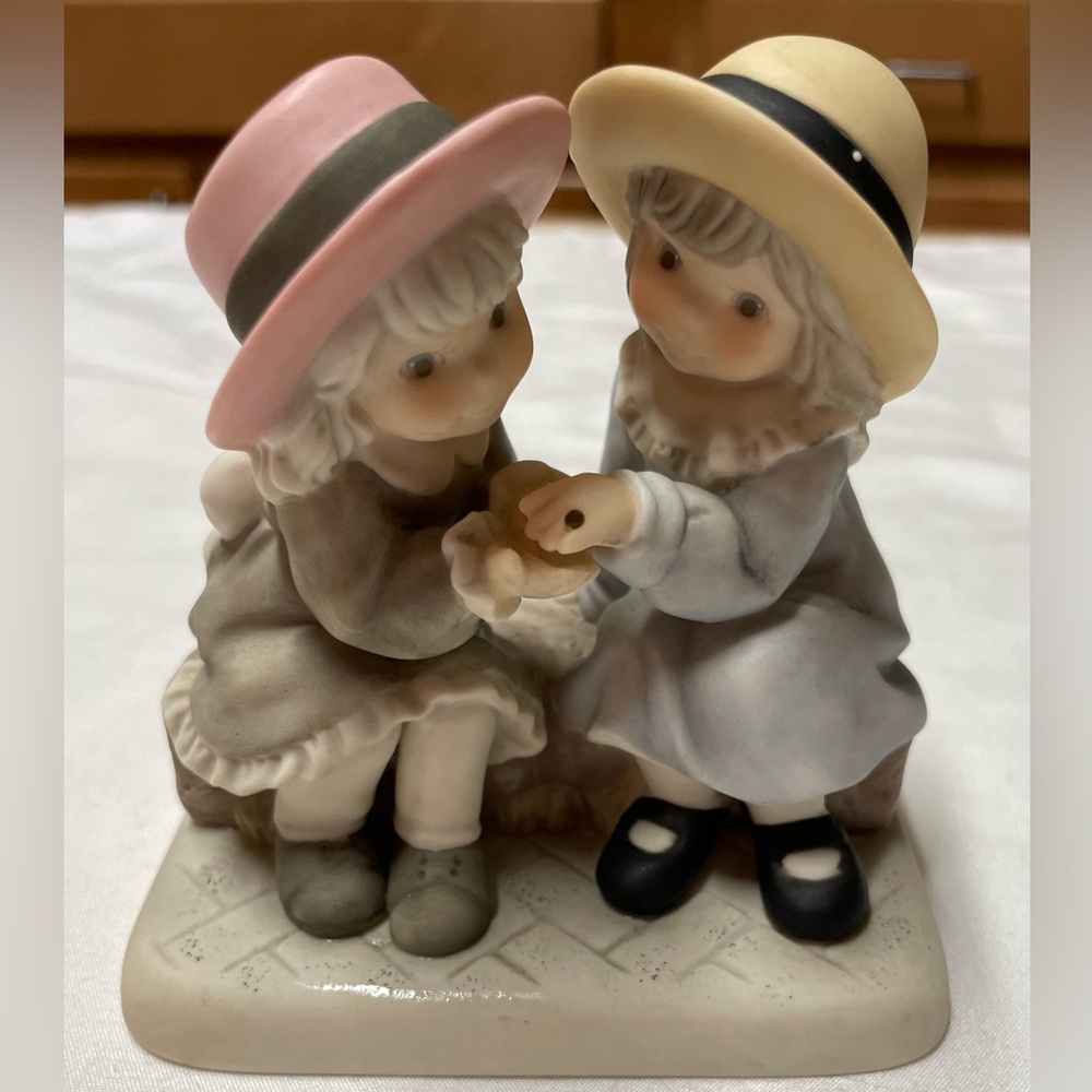 Charming Figurine with Pink and Yellow Hats